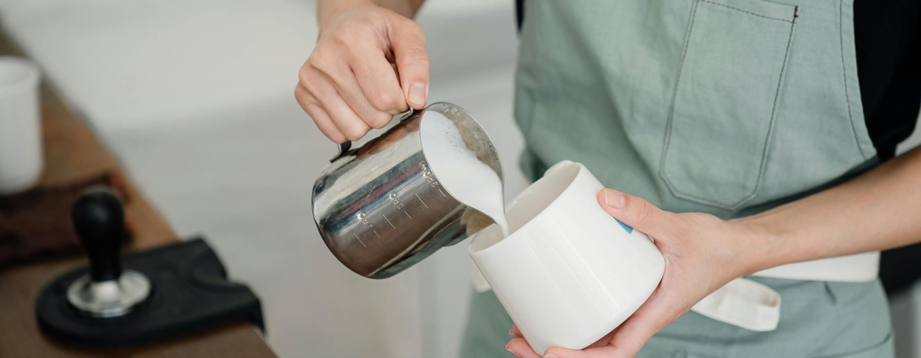 a person pouring a liquid into a glass