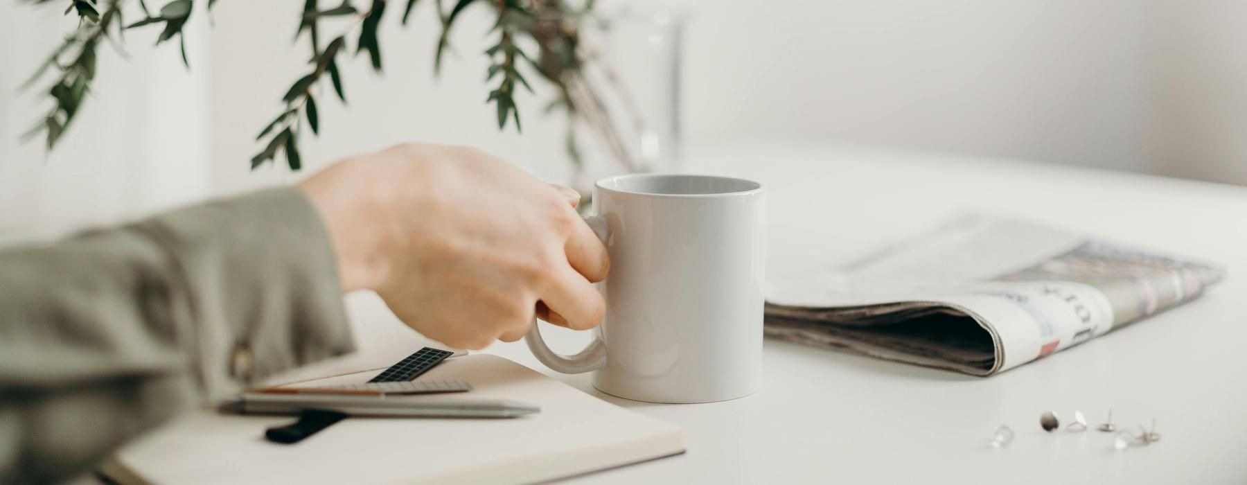 a person holding a coffee cup